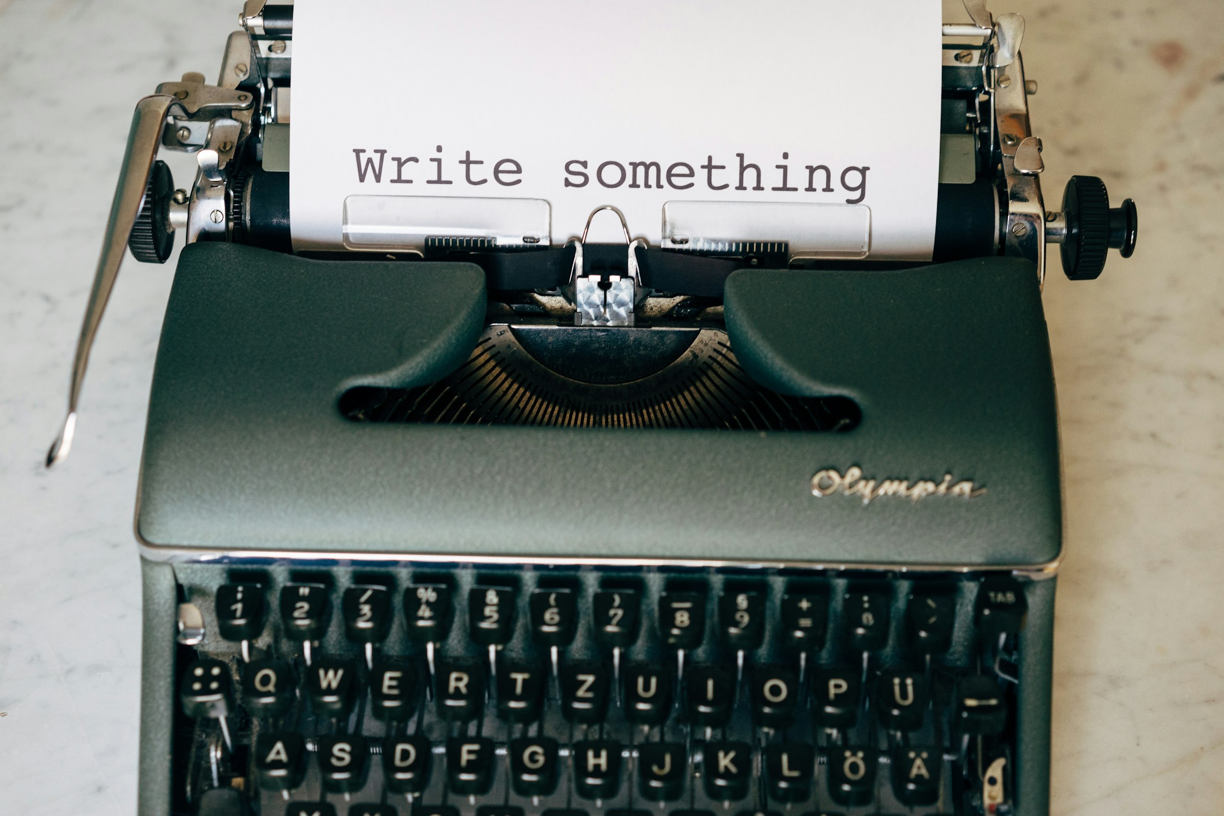 A typewriter with paper reading write something, representing vibe scribing